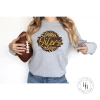 Hustle & Heart NC Faux Glitter Leopard Circle Designs East Alton Oilers Tan Leopard Circle Graphic Tee