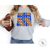 Hustle & Heart NC Rockets Orange/Blue Repeating Graphic Tee Repeating Mascot Designs